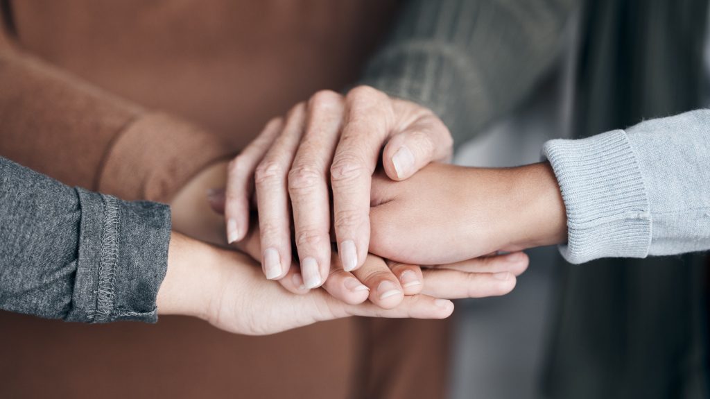 People, hands and care in trust for unity, collaboration or agreement together in solidarity. Hand