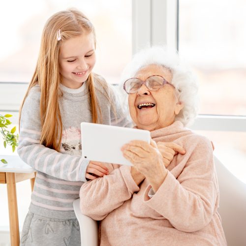 Cute girl helping old lady